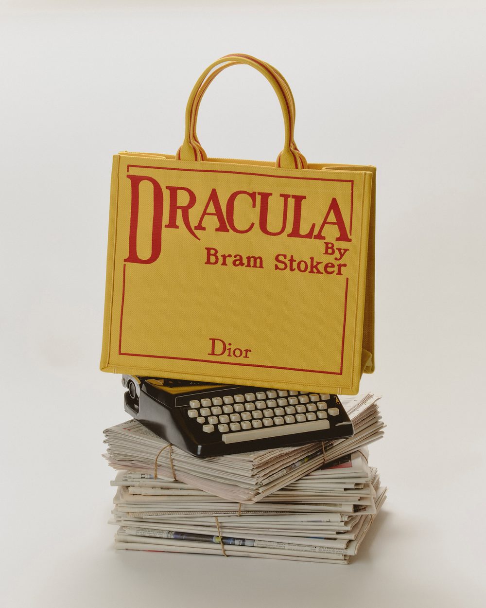 Book-cover tote on a typewriter and newspapers