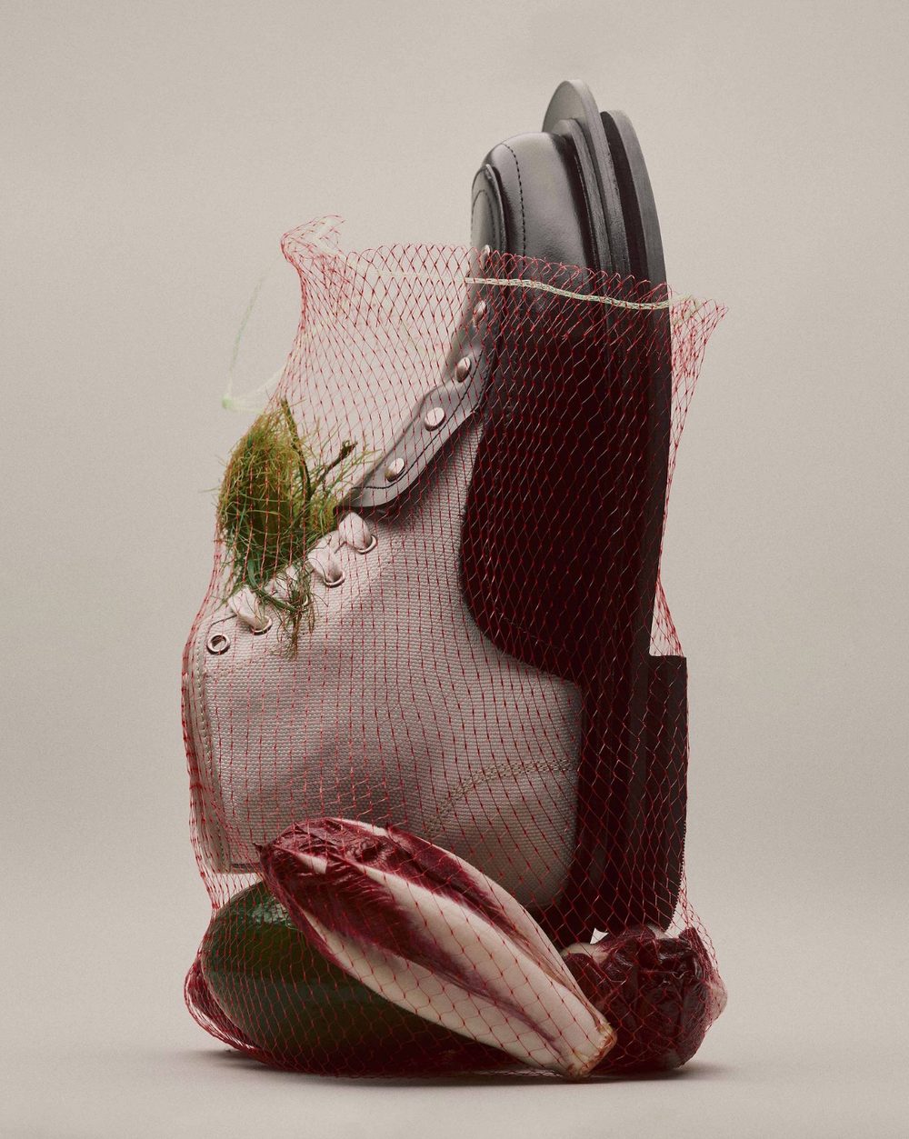 Leather goods and vegetables in a red produce net