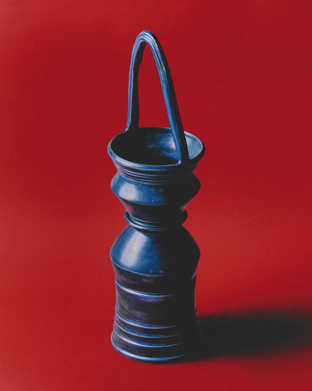 Dark bronze handled vessel on a red ground