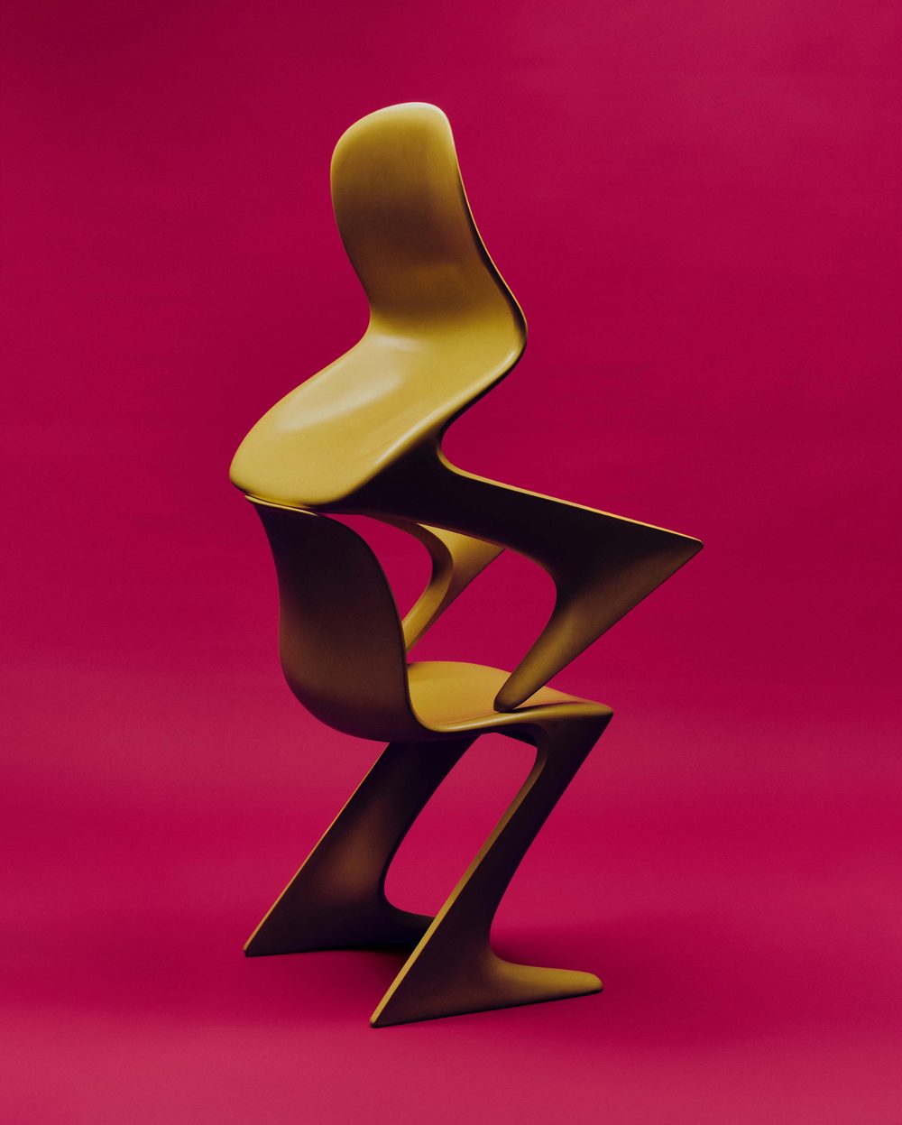 Yellow sculptural chair on a magenta ground